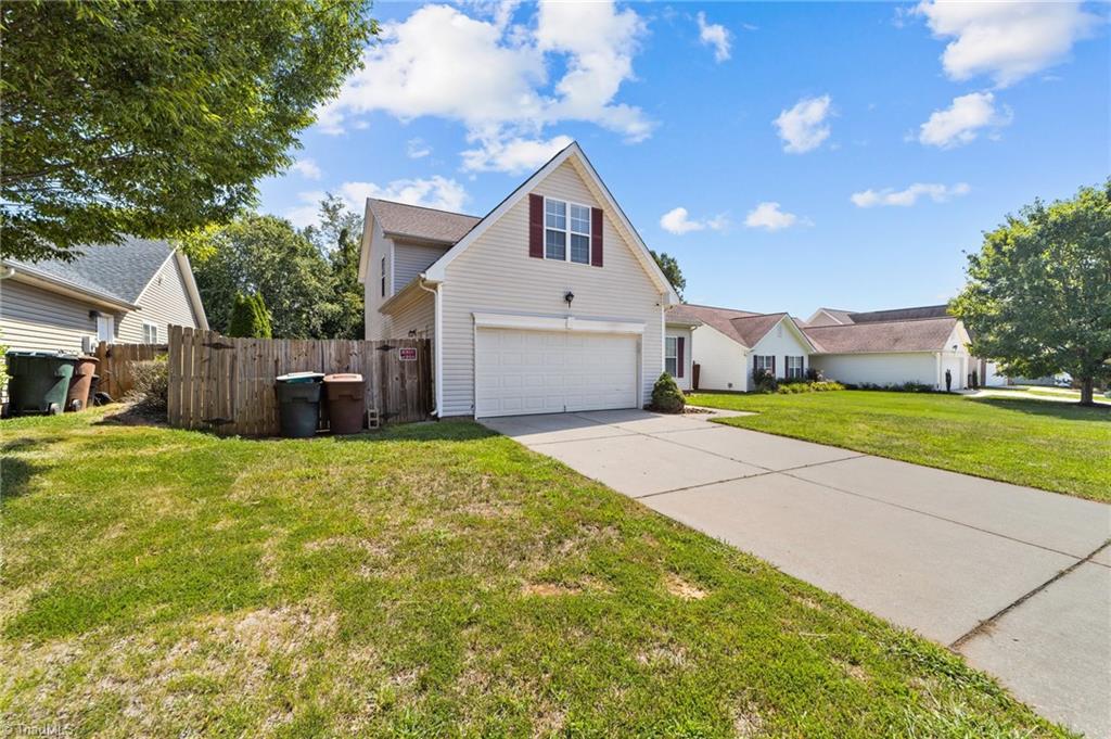 4712 Ridgefall Road Greensboro, NC 27410 - Photo 33 of 44 Front view showing garage and fence.