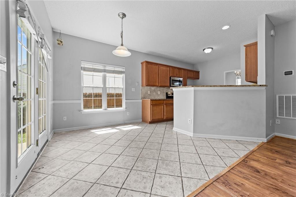 4712 Ridgefall Road Greensboro, NC 27410 - Photo 4 of 44 Sun-lit breakfast nook and access to kitchen.