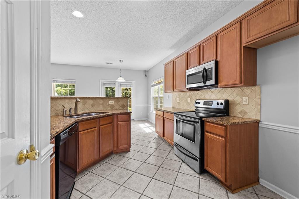 4712 Ridgefall Road Greensboro, NC 27410 - Photo 5 of 44 Spacious kitchen and organized cabinets.