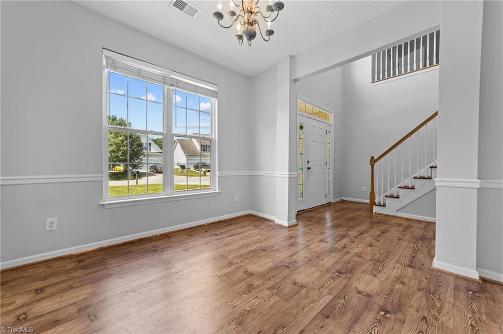 4712 Ridgefall Road Greensboro, NC 27410 - Photo 7 of 44 Dining room area with large windows and access to the foyer.