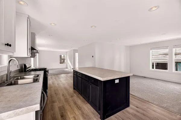 a kitchen with a sink stove and cabinets