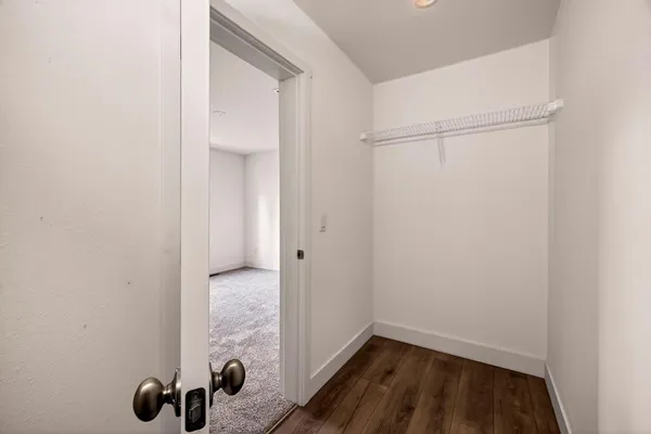 a view of a hallway with wooden floor