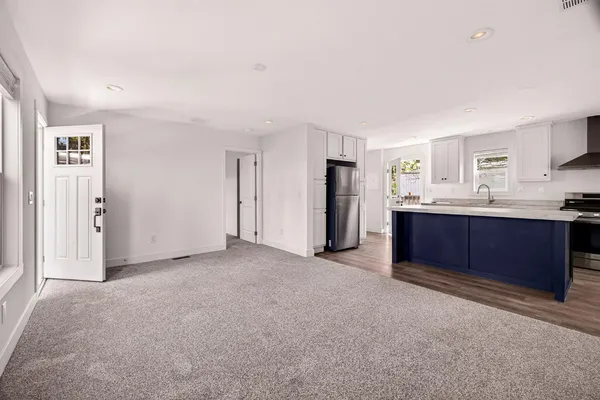 a kitchen with stainless steel appliances granite countertop a refrigerator and a stove top oven
