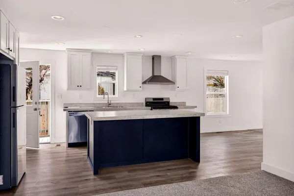 a kitchen with a stove sink and cabinets