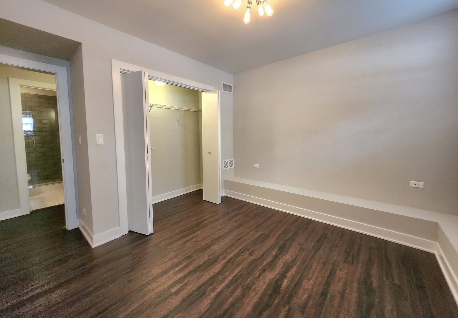 3548 North Racine Avenue, Unit 1 Chicago, IL 60613 - Photo 13 of 19 an empty room with wooden floor and windows