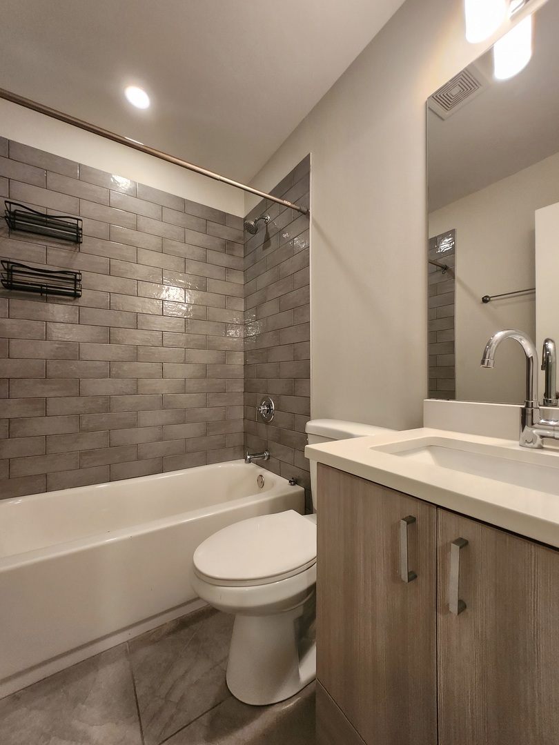 3548 North Racine Avenue, Unit 1 Chicago, IL 60613 - Photo 16 of 19 a bathroom with a sink a toilet and shower