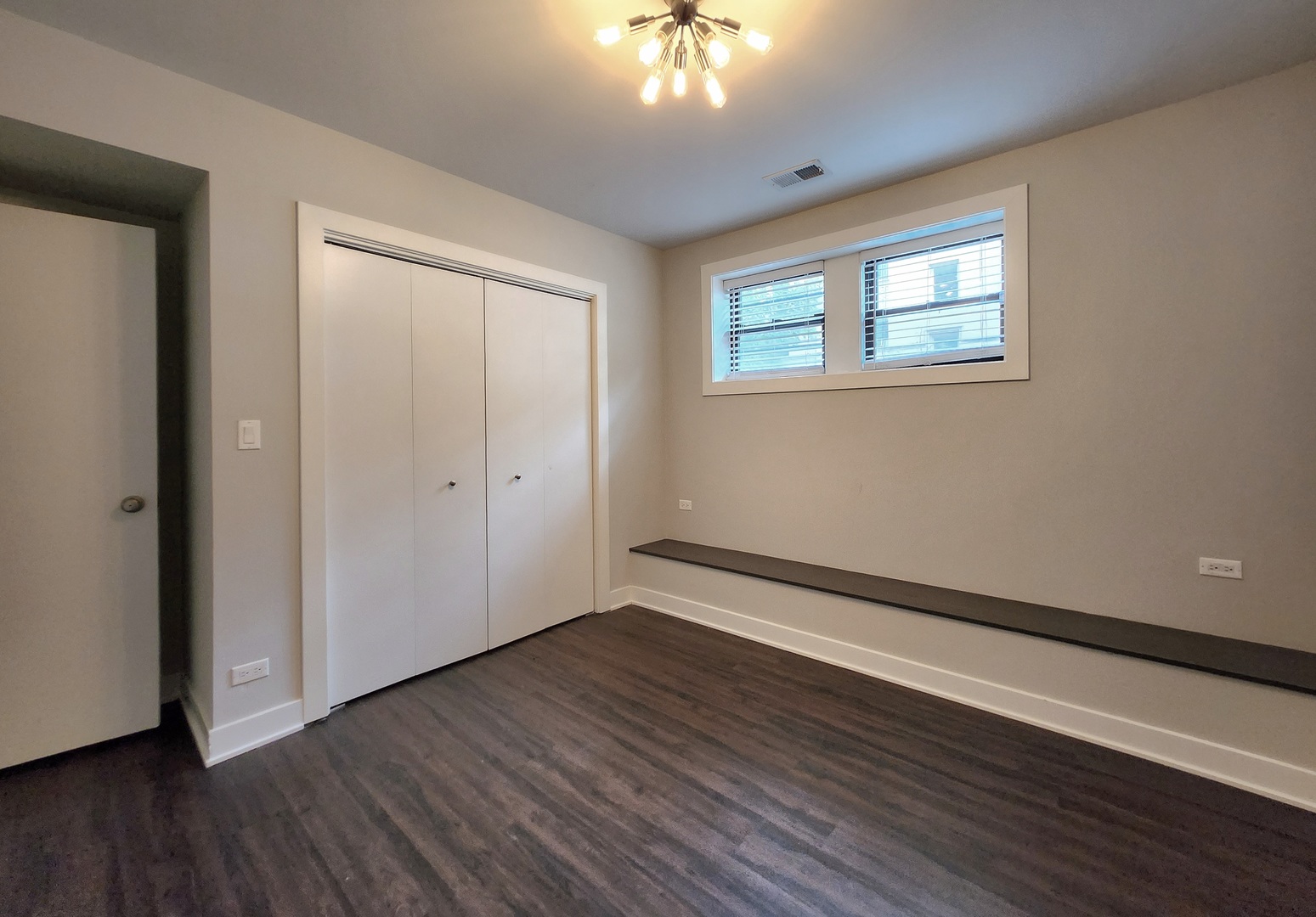 3548 North Racine Avenue, Unit 1 Chicago, IL 60613 - Photo 17 of 19 a view of an empty room with wooden floor and a window