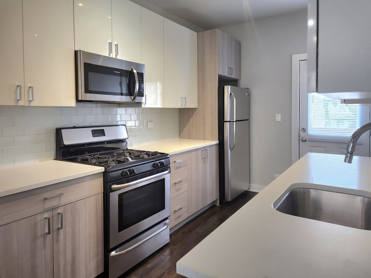 3548 North Racine Avenue, Unit 1 Chicago, IL 60613 - Photo 3 of 19 a kitchen with a sink stove and microwave