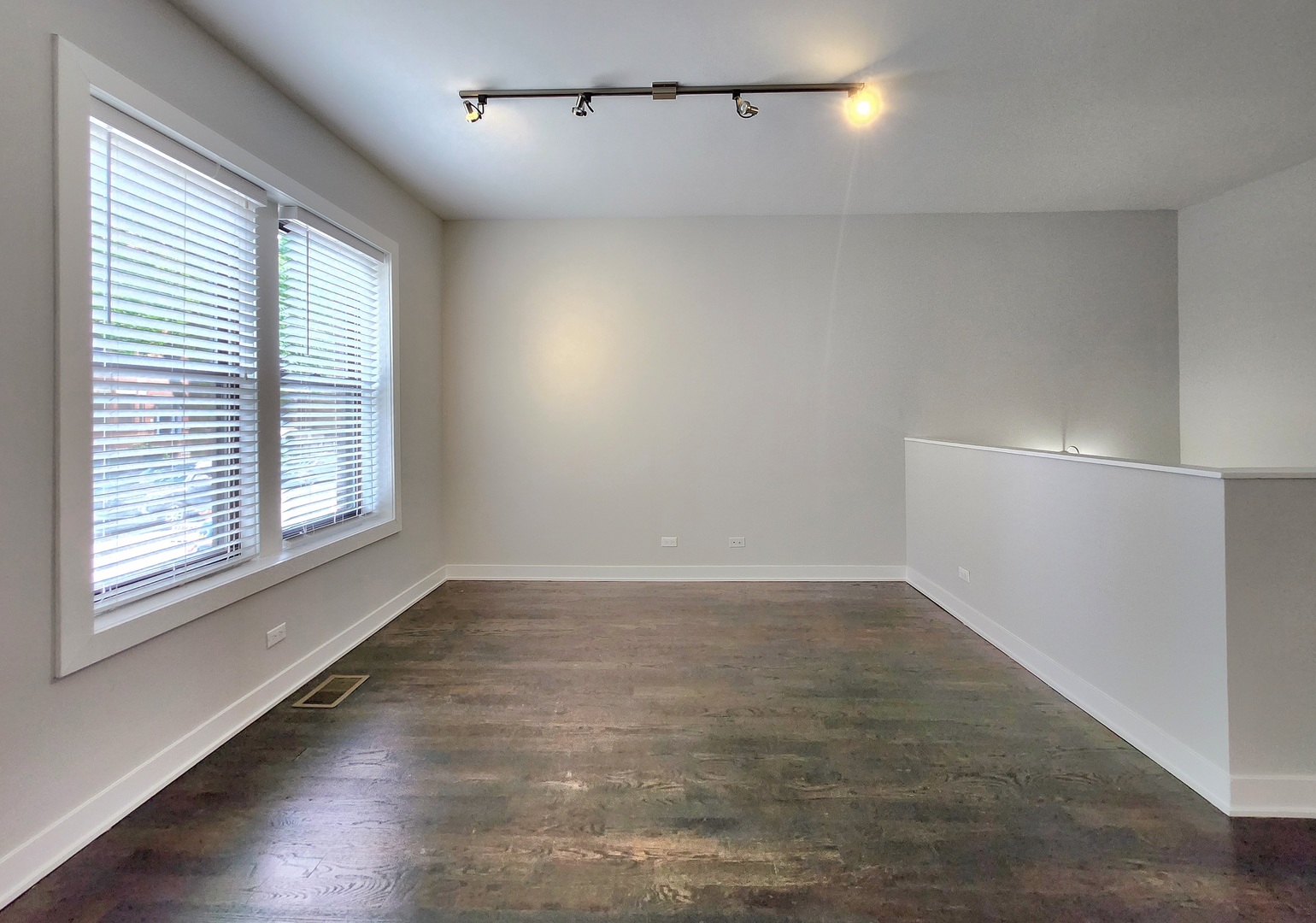 3548 North Racine Avenue, Unit 1 Chicago, IL 60613 - Photo 6 of 19 an empty room with wooden floor and windows