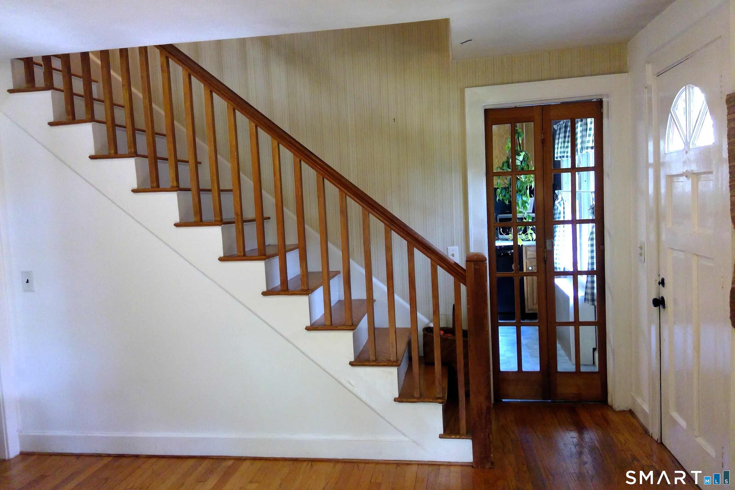 46 Station Road Windham, CT 06256 - Photo 19 of 34 Entryway and stairs to upstairs bedrooms/ Folding doors to kitchen