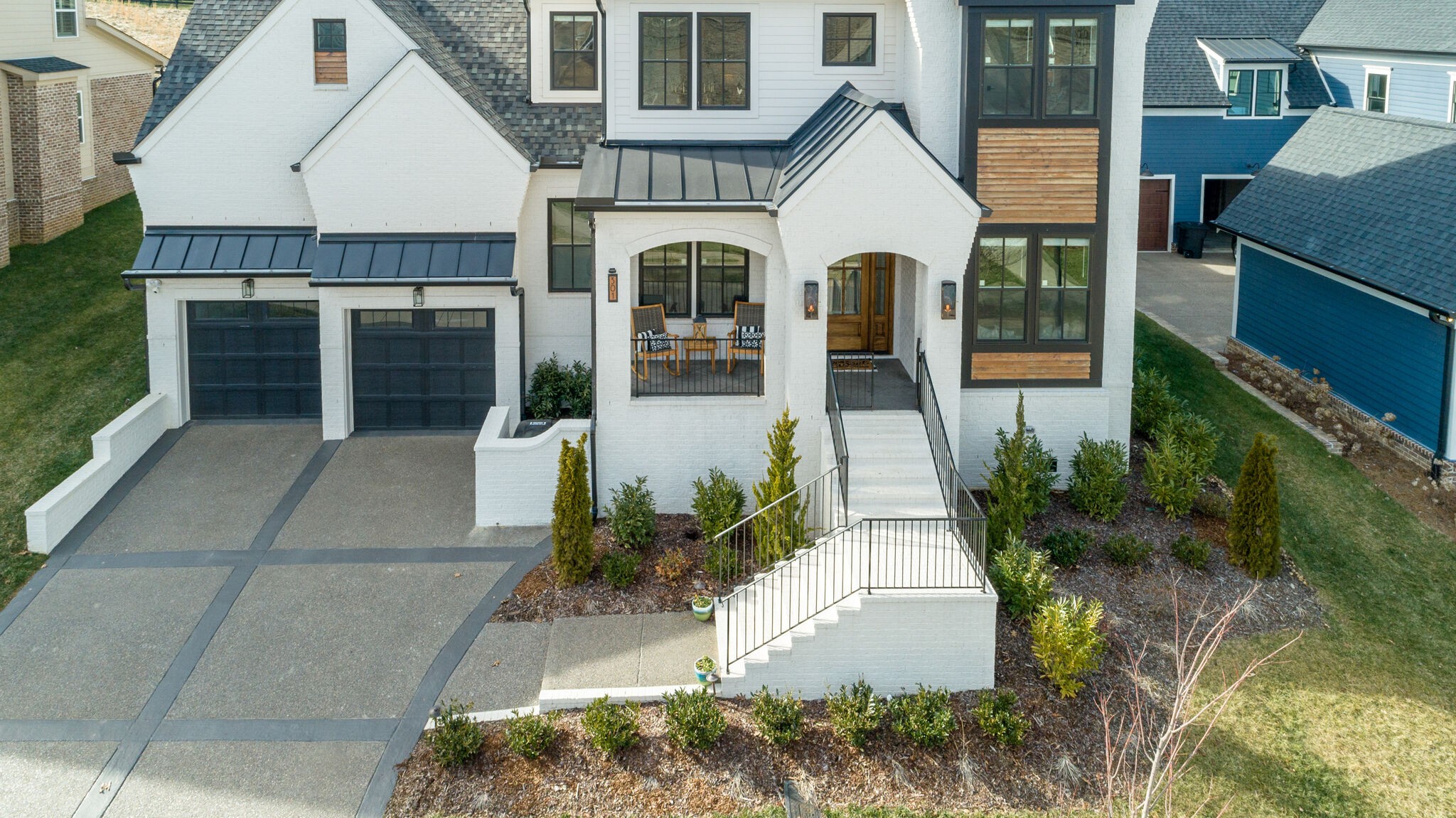 301 Circuit Road Franklin, TN 37064 - Photo 54 of 69 a view of a white house with large windows and plants