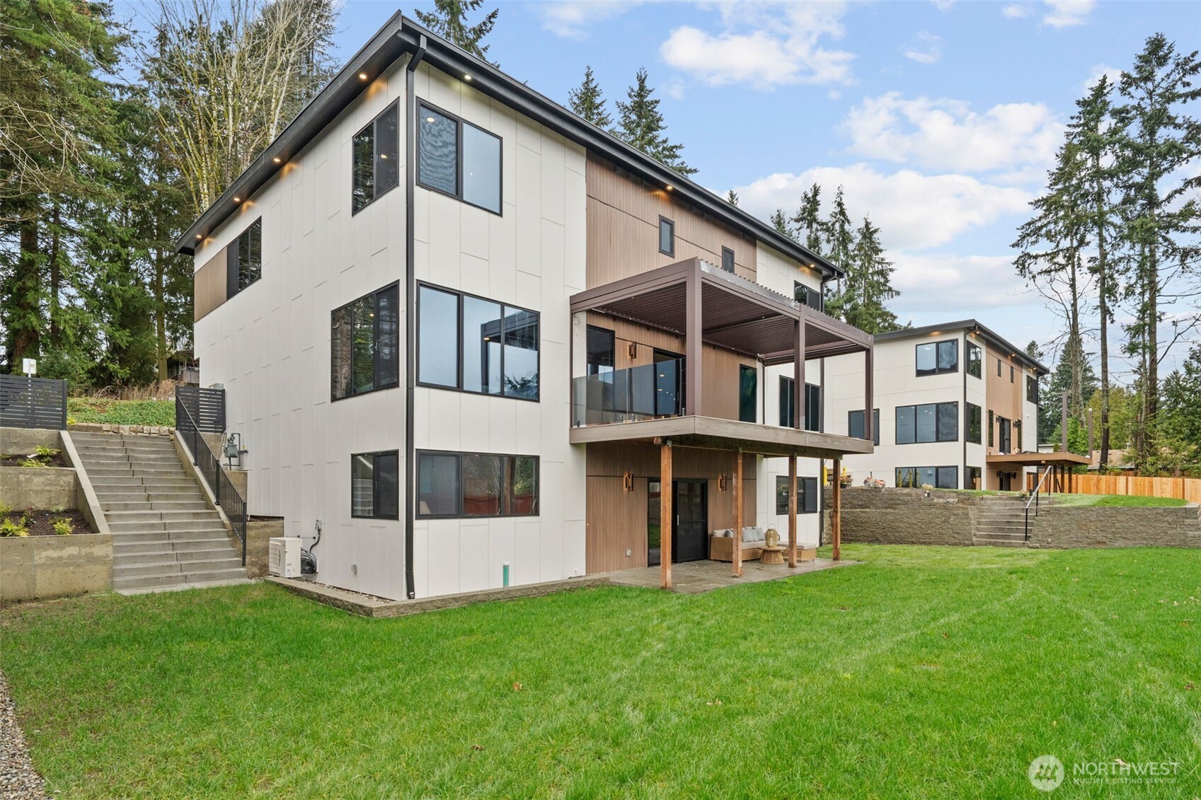 7903 240th Street Southwest Edmonds, WA 98026 - Photo 1 of 35 a view of a white house with a yard and table and chairs