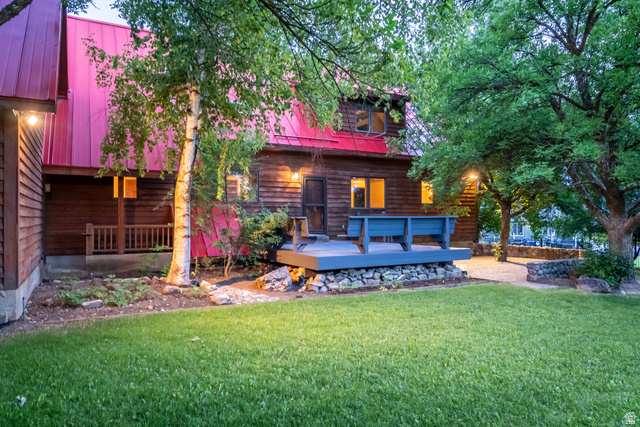 435 Canyon Road Millville, UT 84326 - Photo 76 of 113 Wood-sided residence with a red metal roof and a spacious lawn