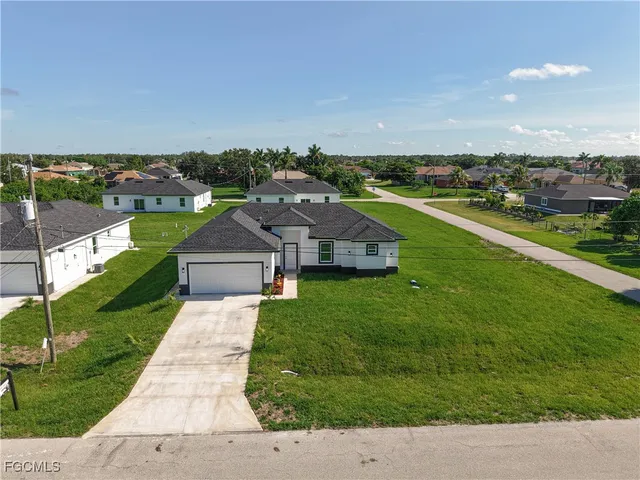 an aerial view of a house with a garden and trees