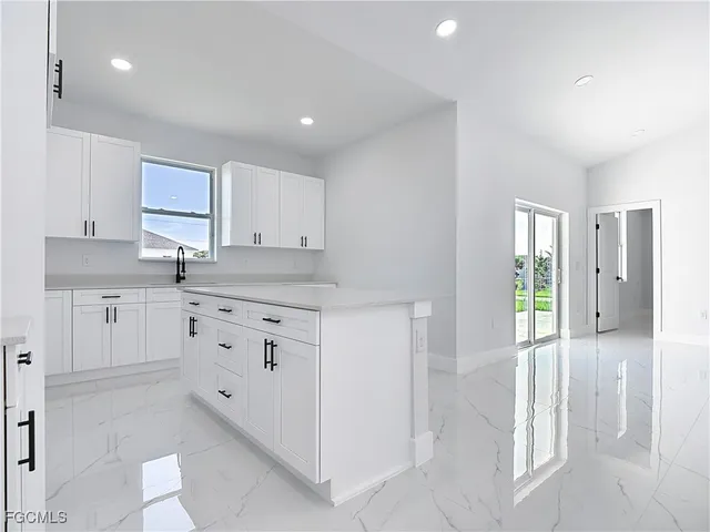 a kitchen with white cabinets