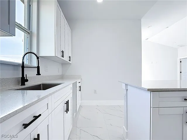 a kitchen with a sink and cabinets