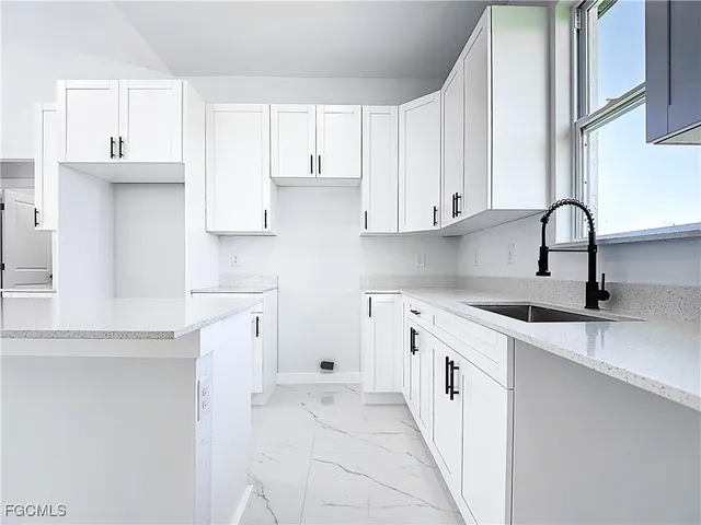 a kitchen with a sink stove and cabinets