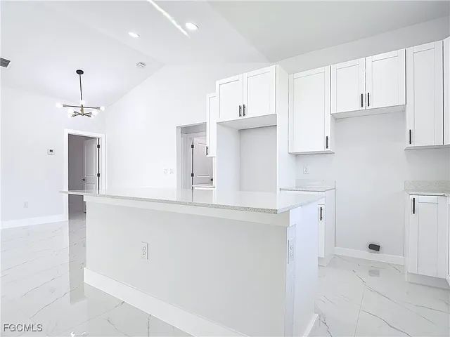 a kitchen with stainless steel appliances a refrigerator and cabinets