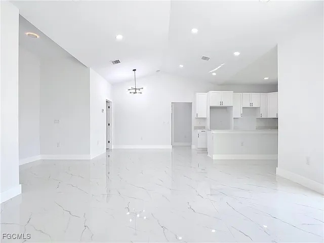 a view of a kitchen with a refrigerator and a sink