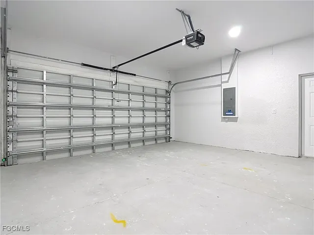 a house that is sitting in the grass with large trees