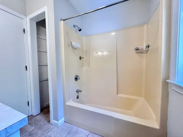 a bathroom with a bathtub and a shower