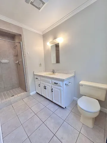 a spacious bathroom with a toilet sink and a mirror