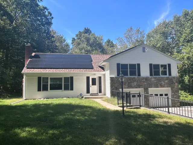 a view of house with a yard
