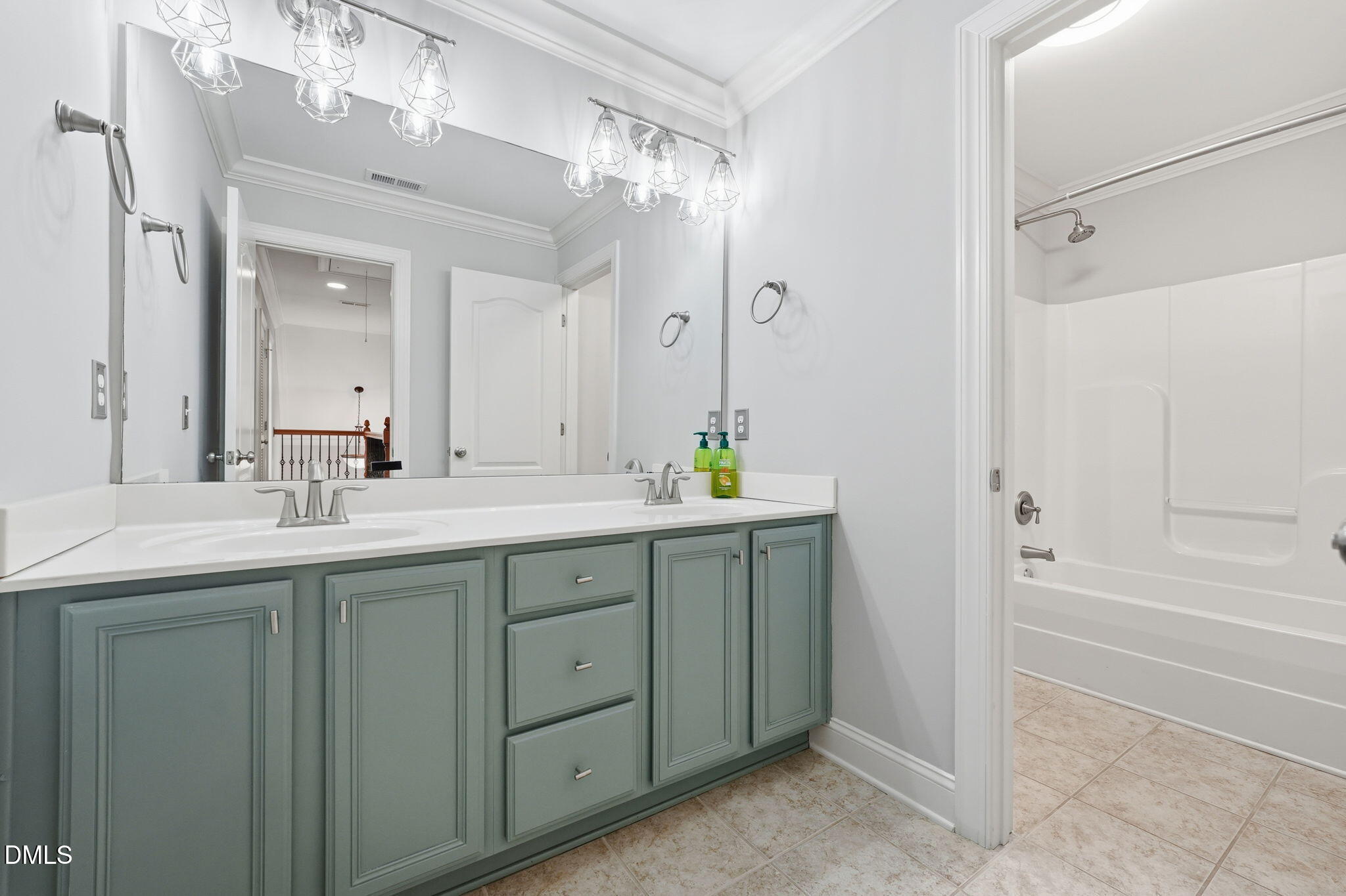 110 Bon Marche Lane Raleigh, NC 27615 - Photo 21 of 25 a bathroom with a shower sink and a mirror