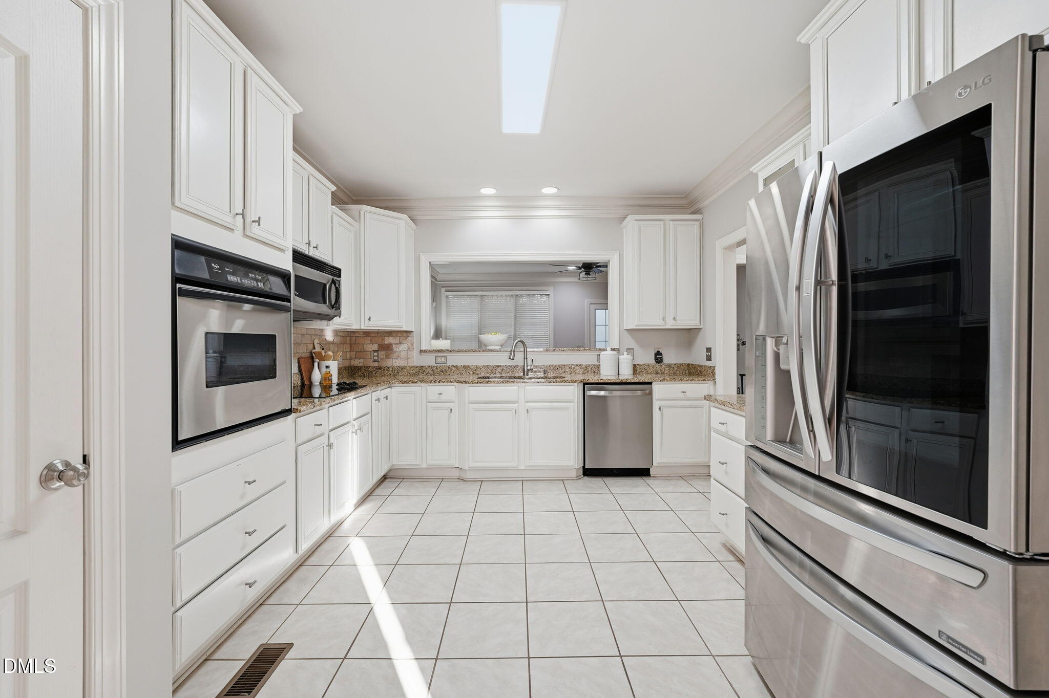 110 Bon Marche Lane Raleigh, NC 27615 - Photo 6 of 25 a kitchen with stainless steel appliances granite countertop a refrigerator a sink a stove top oven and cabinets