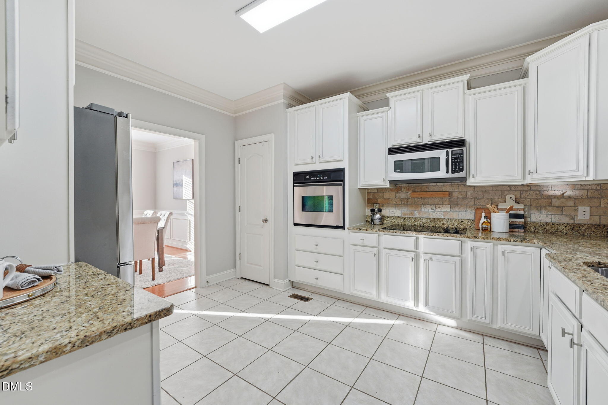 110 Bon Marche Lane Raleigh, NC 27615 - Photo 9 of 25 a kitchen with granite countertop a sink and white cabinets