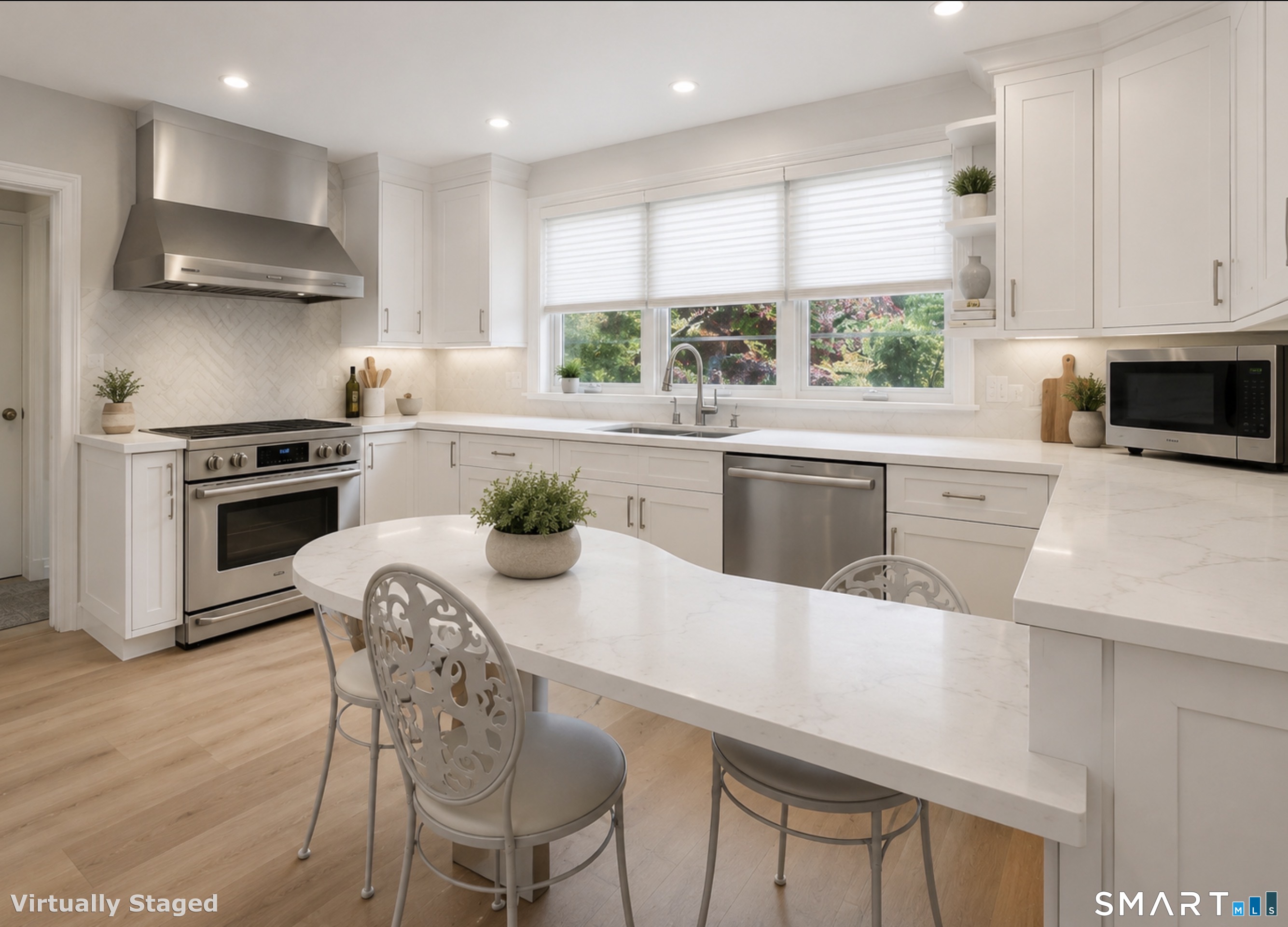 7 Sasqua Road Norwalk, CT 06855 - Photo 15 of 40 a kitchen with kitchen island a stove a table and chairs in it