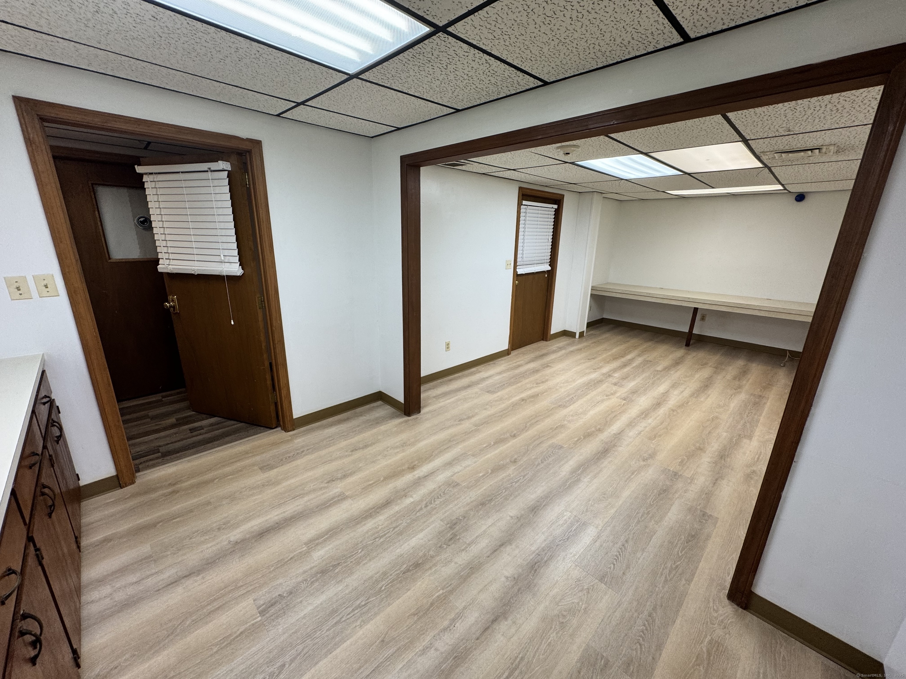 a view of an empty room and wooden floor