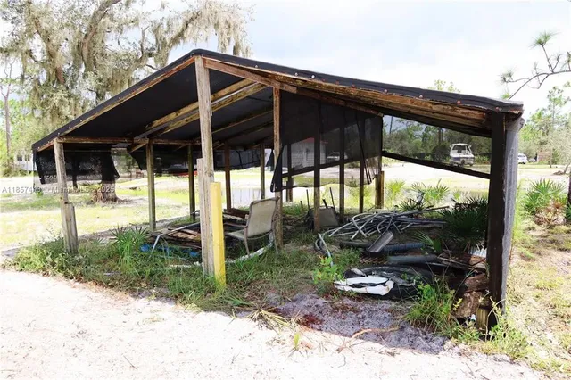 a patio with table and chairs and potted plants