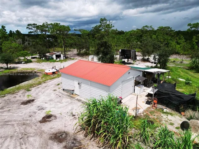 a swimming pool with outdoor seating and garden