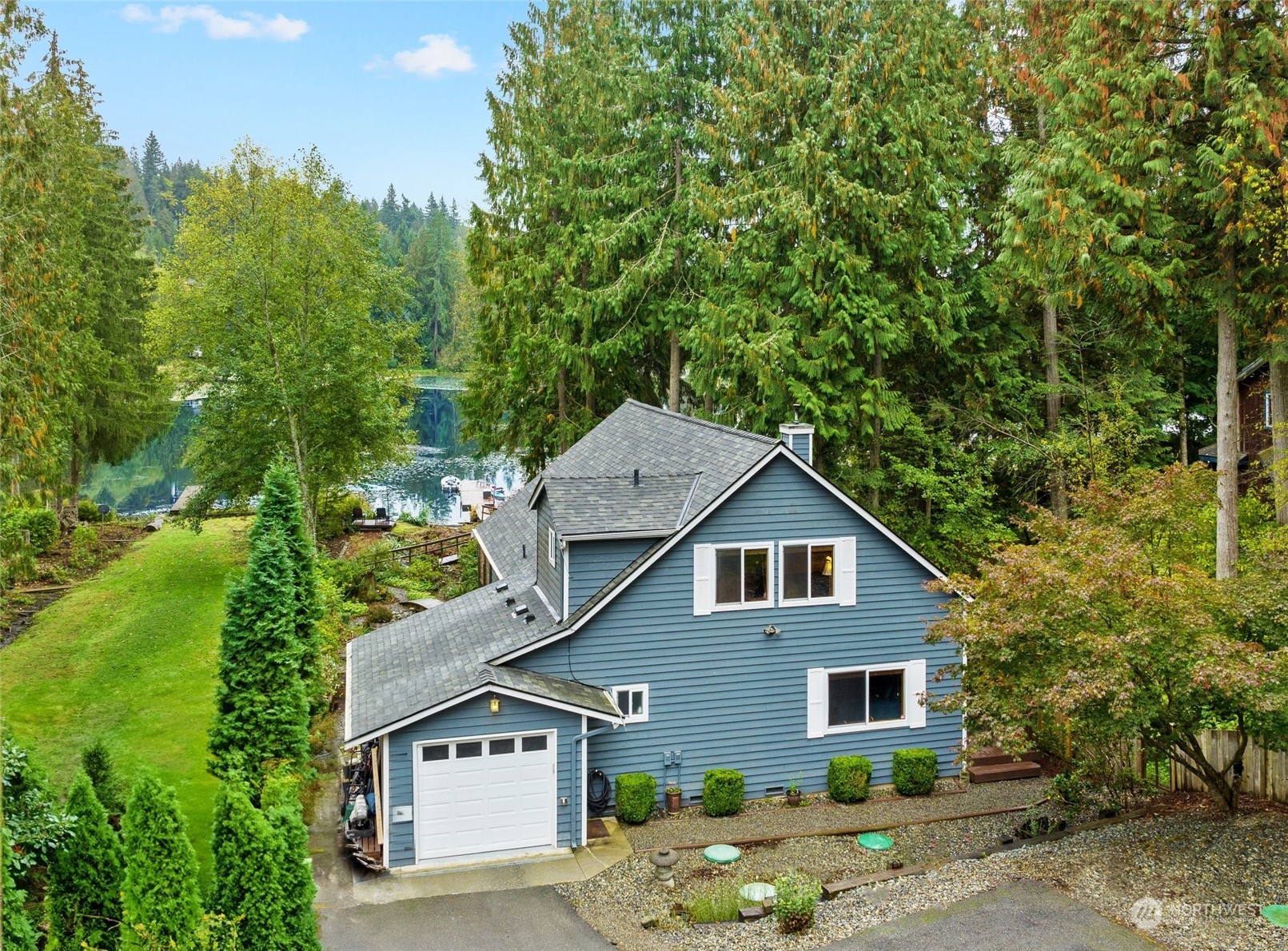 923 Southwest Lake Roesiger Road Snohomish, WA 98290 - Photo 1 of 40 a house with trees in the background