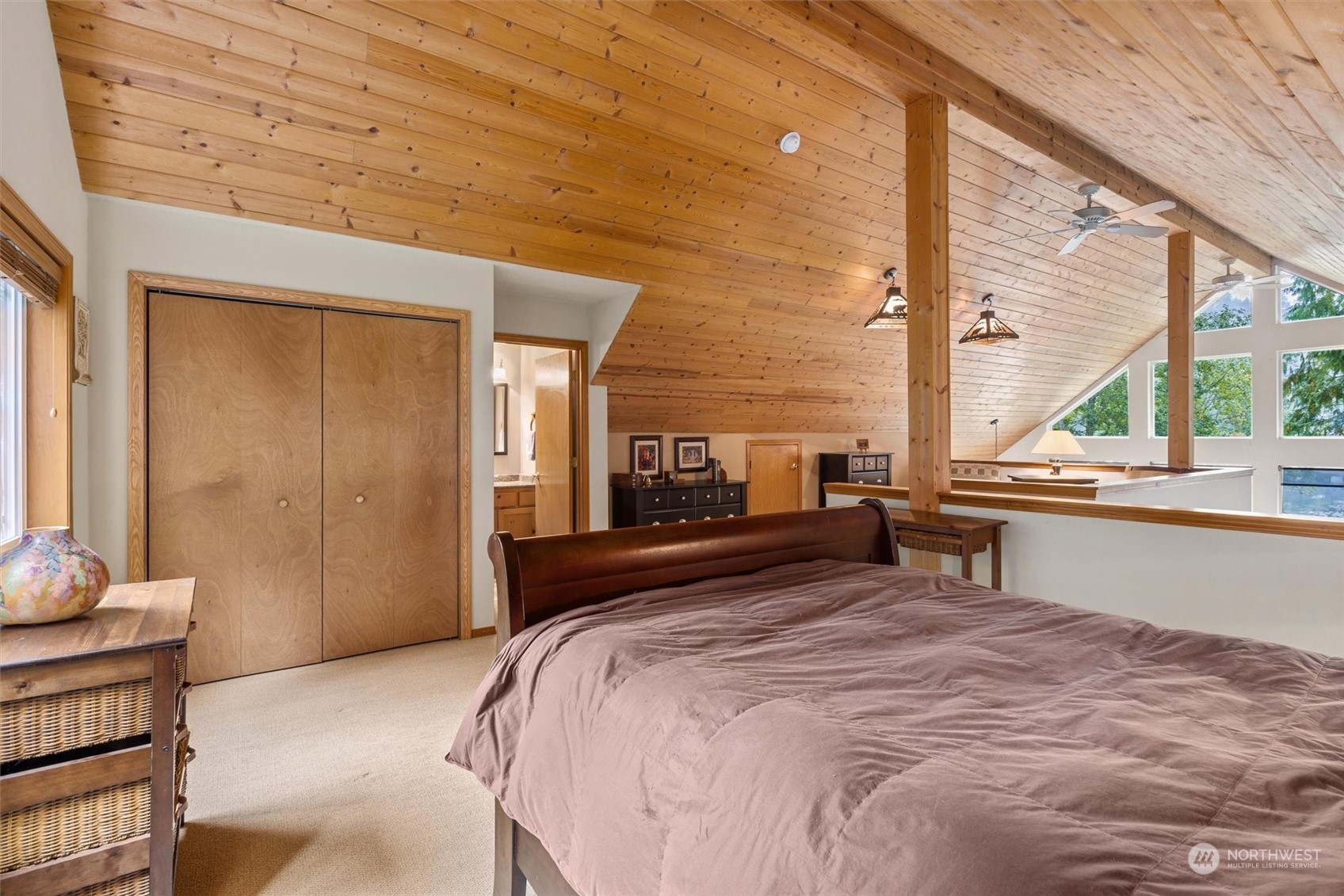 923 Southwest Lake Roesiger Road Snohomish, WA 98290 - Photo 18 of 40 a bedroom with a bed and large windows