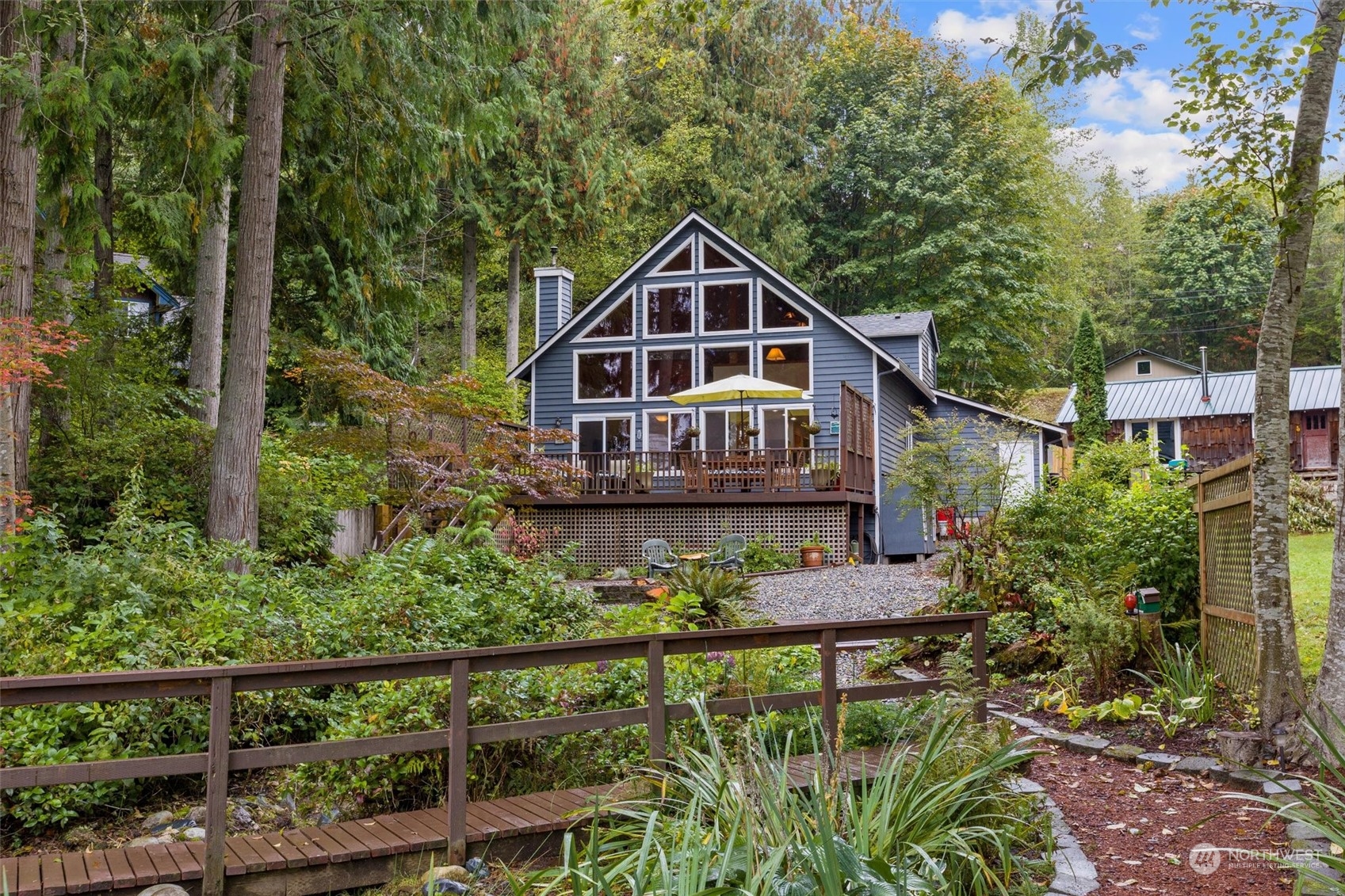 923 Southwest Lake Roesiger Road Snohomish, WA 98290 - Photo 34 of 40 a front view of a house with a yard and potted plants