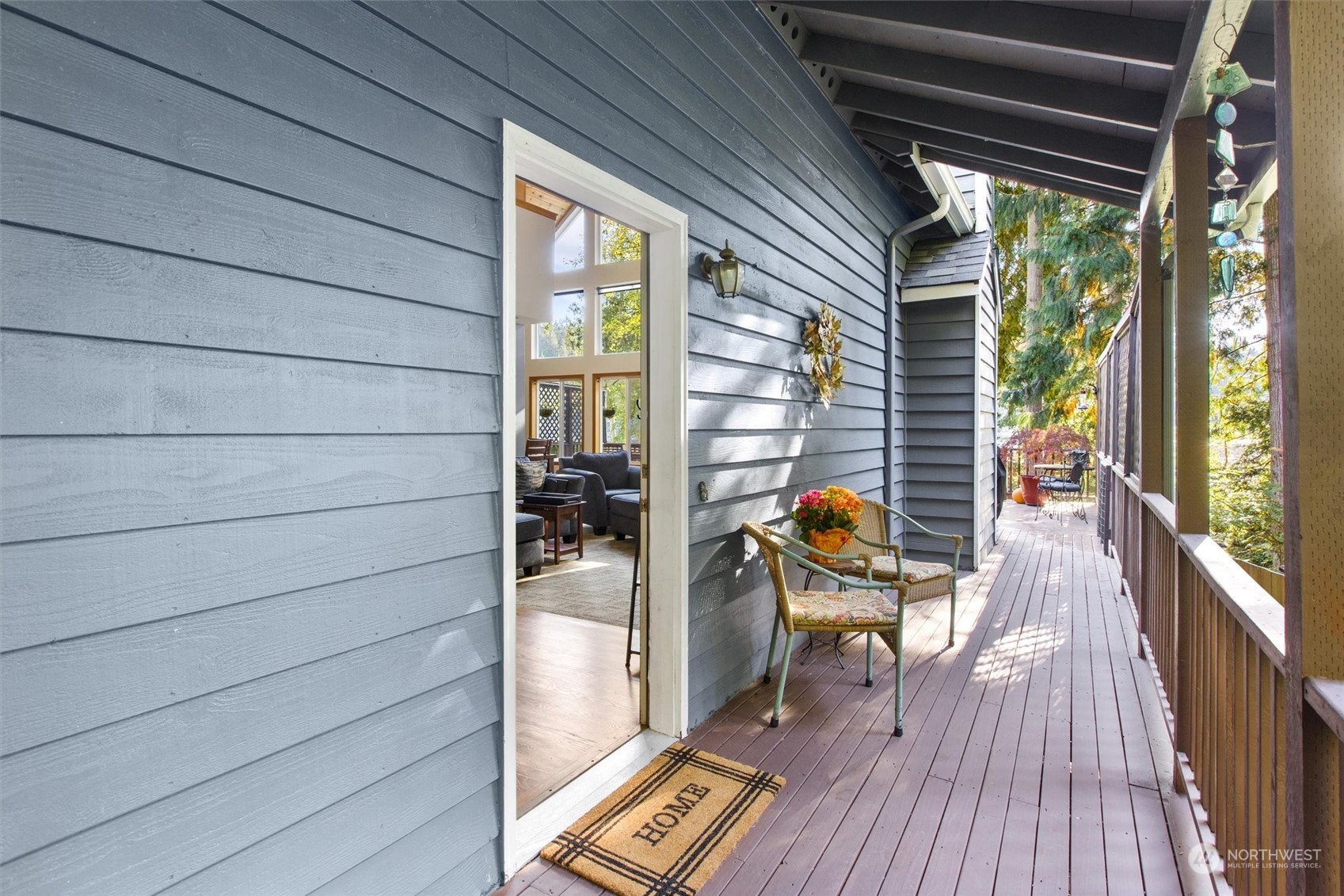 923 Southwest Lake Roesiger Road Snohomish, WA 98290 - Photo 4 of 40 a balcony with wooden floor and outdoor seating