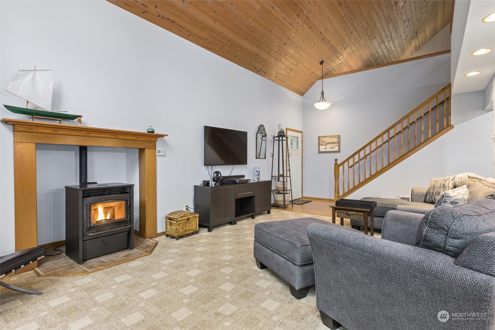 923 Southwest Lake Roesiger Road Snohomish, WA 98290 - Photo 6 of 40 a living room with furniture a flat screen tv and a fireplace