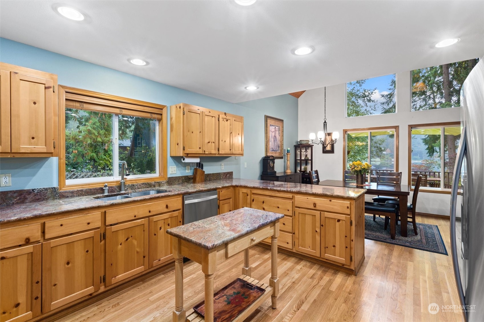 923 Southwest Lake Roesiger Road Snohomish, WA 98290 - Photo 9 of 40 a kitchen with white cabinets and wooden floors