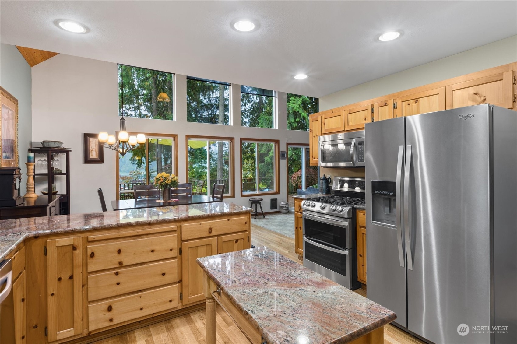 923 Southwest Lake Roesiger Road Snohomish, WA 98290 - Photo 10 of 40 a kitchen with refrigerator a stove and cabinets