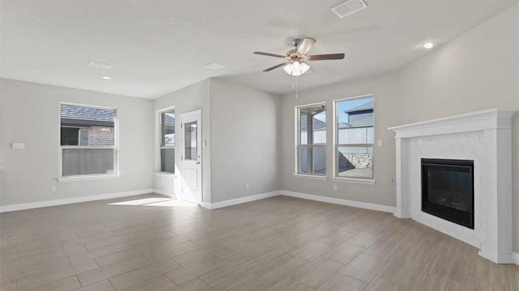11409 Treehouse Trail Justin, TX 76247 - Photo 9 of 39 a view of an empty room with a window and fireplace
