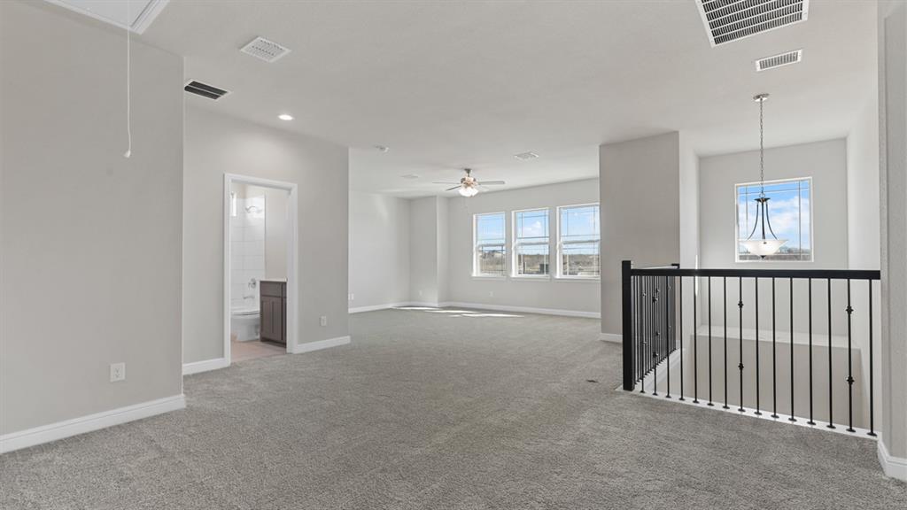 11409 Treehouse Trail Justin, TX 76247 - Photo 24 of 39 an empty room with windows and pillars in it