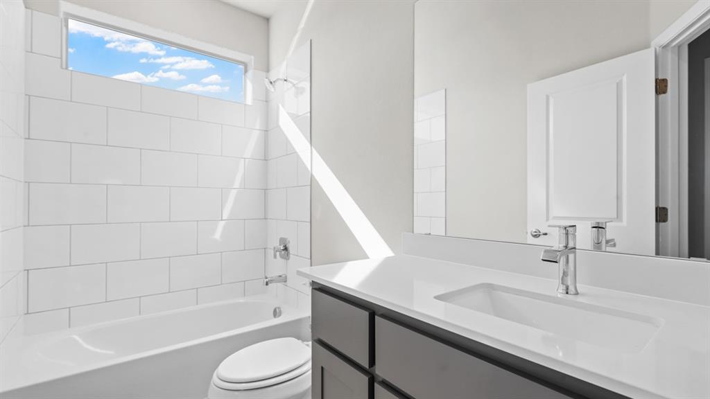 11409 Treehouse Trail Justin, TX 76247 - Photo 31 of 39 a bathroom with a sink a toilet and shower