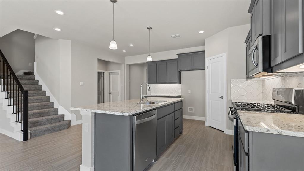 11409 Treehouse Trail Justin, TX 76247 - Photo 3 of 39 a kitchen with a sink appliances and cabinets