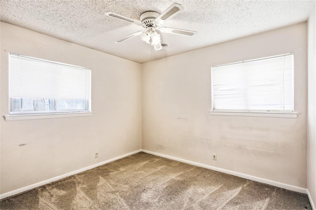 8712 Guadalupe Road Fort Worth, TX 76116 - Photo 13 of 25 wooden floor in an empty room with a window