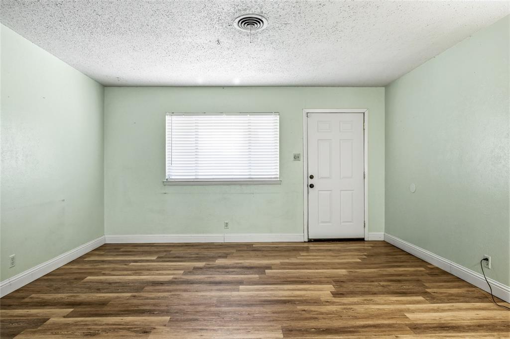 8712 Guadalupe Road Fort Worth, TX 76116 - Photo 5 of 25 a view of a room with wooden floor and white walls