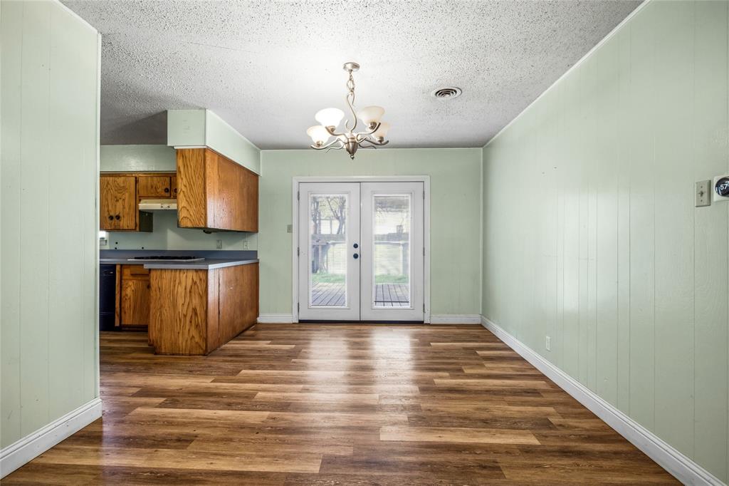 8712 Guadalupe Road Fort Worth, TX 76116 - Photo 7 of 25 a view of a kitchen with granite countertop cabinets and a wooden floor