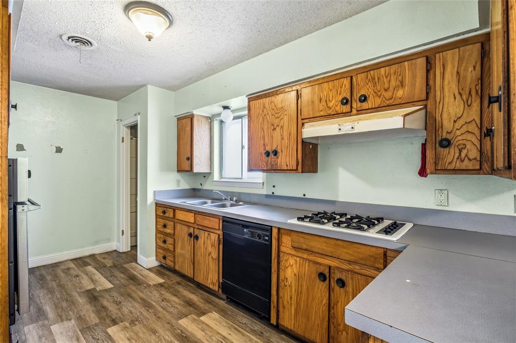 8712 Guadalupe Road Fort Worth, TX 76116 - Photo 8 of 25 a kitchen with stainless steel appliances granite countertop a stove a sink and a refrigerator