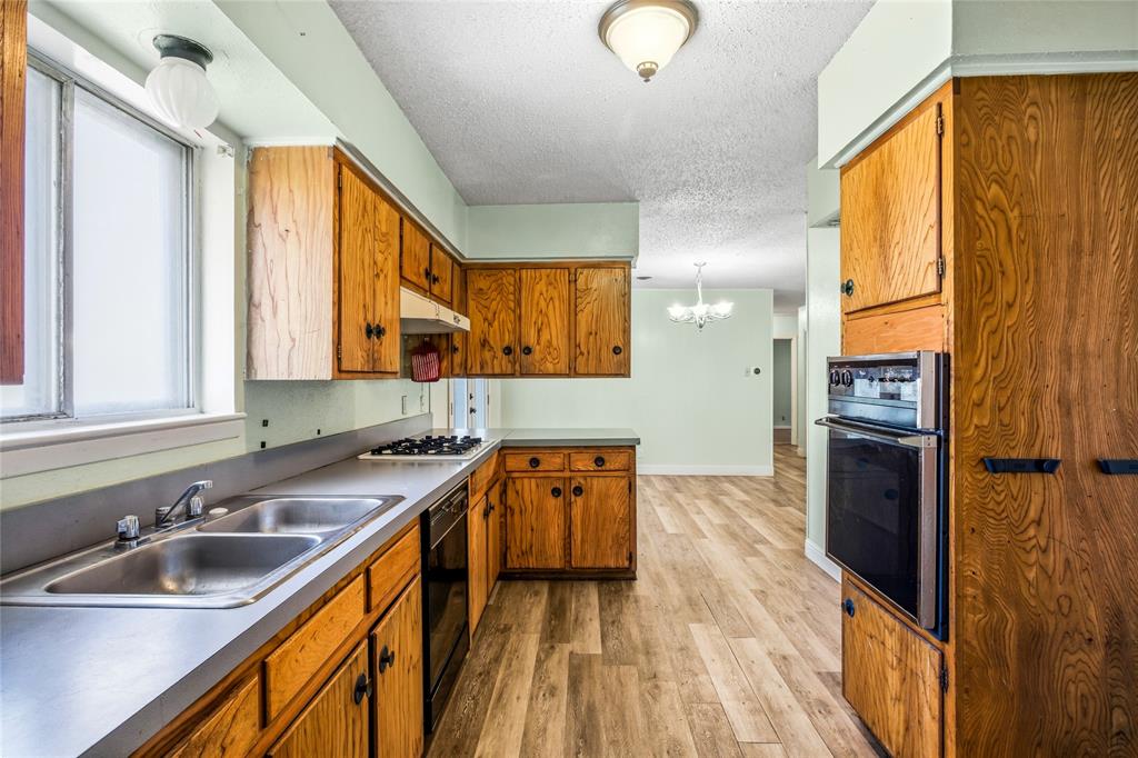 8712 Guadalupe Road Fort Worth, TX 76116 - Photo 9 of 25 a kitchen with stainless steel appliances granite countertop a sink a stove and a refrigerator